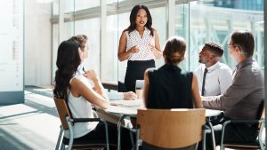 Underwriters hold a meeting around a small conference table